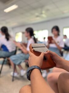 students from Vinnie Classroom playing Kalimba